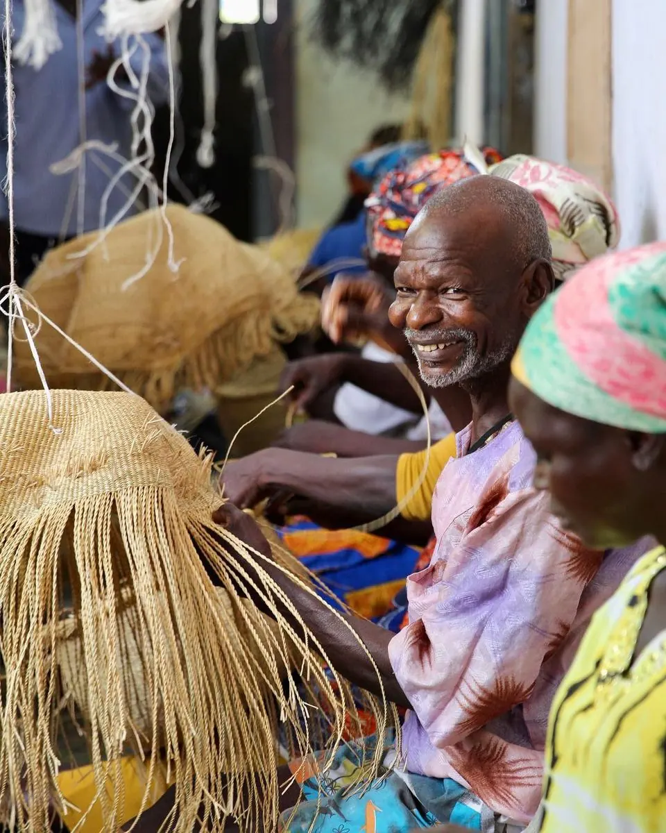 Basket makers shaping baskets as they weave